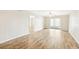 Spacious living room with wood-look floors and access to balcony at 3777 Lake Bayshore Dr # H401, Bradenton, FL 34205