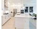 Modern kitchen with white cabinets, quartz countertops, and stainless steel appliances at 1922 6Th St E, Palmetto, FL 34221