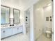 Bathroom featuring double vanity, walk-in shower, and toilet at 1922 6Th St E, Palmetto, FL 34221