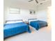 Guest bedroom with two twin beds and calming decor at 1922 6Th St E, Palmetto, FL 34221