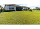 Spacious backyard with grassy lawn and screened patio at 1922 6Th St E, Palmetto, FL 34221