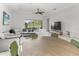 Bright living room with sectional sofa, dining table, and view to backyard at 1922 6Th St E, Palmetto, FL 34221