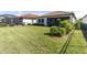 Landscaped backyard with grassy lawn and privacy fence at 1922 6Th St E, Palmetto, FL 34221