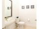 Small half bathroom with toilet and sink at 1922 6Th St E, Palmetto, FL 34221