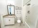 Clean bathroom with tub shower combo, vanity, and toilet at 1922 6Th St E, Palmetto, FL 34221