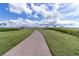 Curving brick pathway through grassy area toward waterfront at 1922 6Th St E, Palmetto, FL 34221