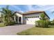 One-story home with a tile roof, white garage door, and landscaped yard at 1922 6Th St E, Palmetto, FL 34221