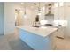Modern kitchen with white cabinets, quartz countertops, and stainless steel appliances at 1922 6Th St E, Palmetto, FL 34221