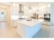 Modern kitchen with white cabinets, quartz countertops, and stainless steel appliances at 1922 6Th St E, Palmetto, FL 34221