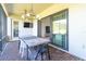 Covered patio with dining table and sliding glass doors at 1922 6Th St E, Palmetto, FL 34221