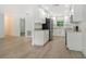 Bright kitchen features white cabinets, stainless steel appliances, and light-colored countertops at 4724 Seville Dr, Sarasota, FL 34235