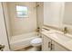 Clean bathroom, featuring a bathtub, toilet and vanity with quartz countertop at 4724 Seville Dr, Sarasota, FL 34235