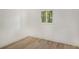 Bright bedroom with vinyl flooring and a window with shutters at 4724 Seville Dr, Sarasota, FL 34235
