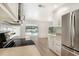 Kitchen with stainless steel appliances and view of the pool through sliding doors at 4724 Seville Dr, Sarasota, FL 34235