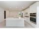 Bright kitchen featuring white cabinets, stainless steel appliances, and an island at 4254 Golden Creek Ter, Parrish, FL 34219