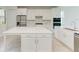 Modern kitchen with white cabinets, large island, and stainless steel appliances at 4254 Golden Creek Ter, Parrish, FL 34219