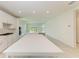 Open concept kitchen with white cabinetry and expansive island at 4254 Golden Creek Ter, Parrish, FL 34219