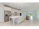 Modern kitchen with white cabinets, large island, and stainless steel appliances at 4254 Golden Creek Ter, Parrish, FL 34219