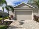 Two-car garage and paver driveway with landscaping at 4254 Golden Creek Ter, Parrish, FL 34219