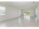 Spacious living room with tile floors and sliding glass doors leading to the patio at 4254 Golden Creek Ter, Parrish, FL 34219