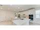 Modern kitchen with white cabinets, stainless steel appliances, and a large island at 4254 Golden Creek Ter, Parrish, FL 34219