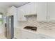 Modern kitchen with white cabinets, stainless steel appliances, and gas cooktop at 4254 Golden Creek Ter, Parrish, FL 34219