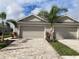 Two-car garage with paver driveway and landscaping at 4254 Golden Creek Ter, Parrish, FL 34219