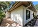 Side view of a light-colored villa with a brick walkway at 3601 Quail Hollow Ln, Bradenton, FL 34210