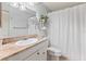 Bathroom with granite countertop, white cabinets, and shower at 3601 Quail Hollow Ln, Bradenton, FL 34210