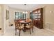 Bright dining room with a round table and wood hutch at 3601 Quail Hollow Ln, Bradenton, FL 34210