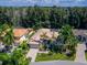 Aerial view of single-Gathering home with pool and lush landscaping at 12313 Baypointe Ter, Cortez, FL 34215