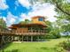 Elevated community building with large windows and a slide at 12313 Baypointe Ter, Cortez, FL 34215