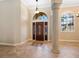 Bright entryway with tile flooring, a decorative inlay, and a wood door at 12313 Baypointe Ter, Cortez, FL 34215