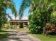 Farm stand with a tractor and lush greenery at 12313 Baypointe Ter, Cortez, FL 34215