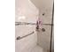 Walk-in shower with grab bar and updated tile at 5933 17Th W St # A24, Bradenton, FL 34207