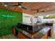 Outdoor bar with wood cabinetry, a sink, and a green wall at 3811 Bayside Cir, Bradenton, FL 34210