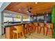 L-shaped outdoor bar with wooden barstools and a TV at 3811 Bayside Cir, Bradenton, FL 34210