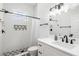 Modern bathroom with white tile, geometric floor, and updated fixtures at 3811 Bayside Cir, Bradenton, FL 34210