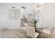 Bright dining area with glass-top table and modern white chairs at 3811 Bayside Cir, Bradenton, FL 34210