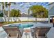Stunning pool view with lounge chairs and a beautiful backyard at 3811 Bayside Cir, Bradenton, FL 34210