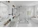 Elegant bathroom with marble shower, double vanity, and soaking tub at 3811 Bayside Cir, Bradenton, FL 34210