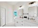 Double vanity bathroom with modern fixtures and large mirrors at 3811 Bayside Cir, Bradenton, FL 34210