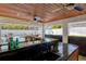 Outdoor kitchen bar with granite countertop and pool view at 3811 Bayside Cir, Bradenton, FL 34210