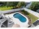 Relaxing kidney-shaped pool with lounge chairs, surrounded by a grassy backyard at 3811 Bayside Cir, Bradenton, FL 34210