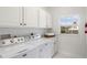 Bright laundry room with washer, dryer, and cabinets at 3811 Bayside Cir, Bradenton, FL 34210