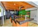 Covered outdoor bar with wood finishes, a TV, and a neon sign at 3811 Bayside Cir, Bradenton, FL 34210