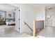 Upstairs hallway with light wood stairs and modern railing at 3811 Bayside Cir, Bradenton, FL 34210