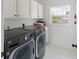 Clean laundry room with washer, dryer, and cabinets at 3811 Bayside Cir, Bradenton, FL 34210