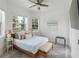 Bright bedroom with a wooden bed, window seats, and coastal decor at 3811 Bayside Cir, Bradenton, FL 34210
