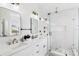 Double vanity bathroom with marble shower and modern fixtures at 3811 Bayside Cir, Bradenton, FL 34210